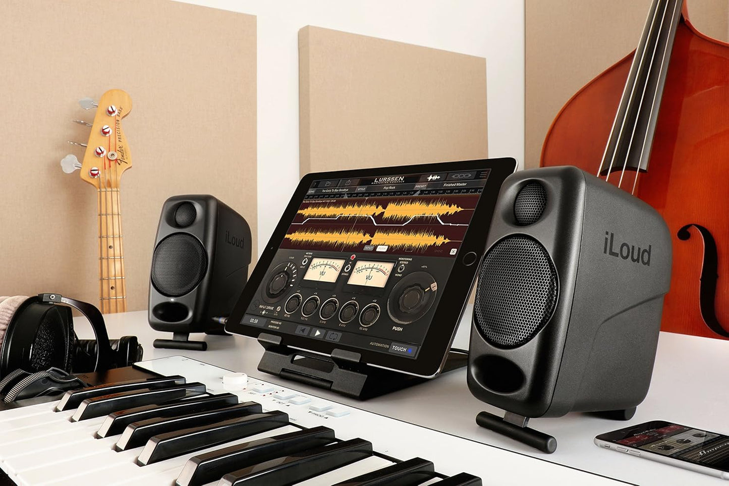 iLoud Micro Studio Monitors on a music workstation with keyboard and tablet for audio mixing
