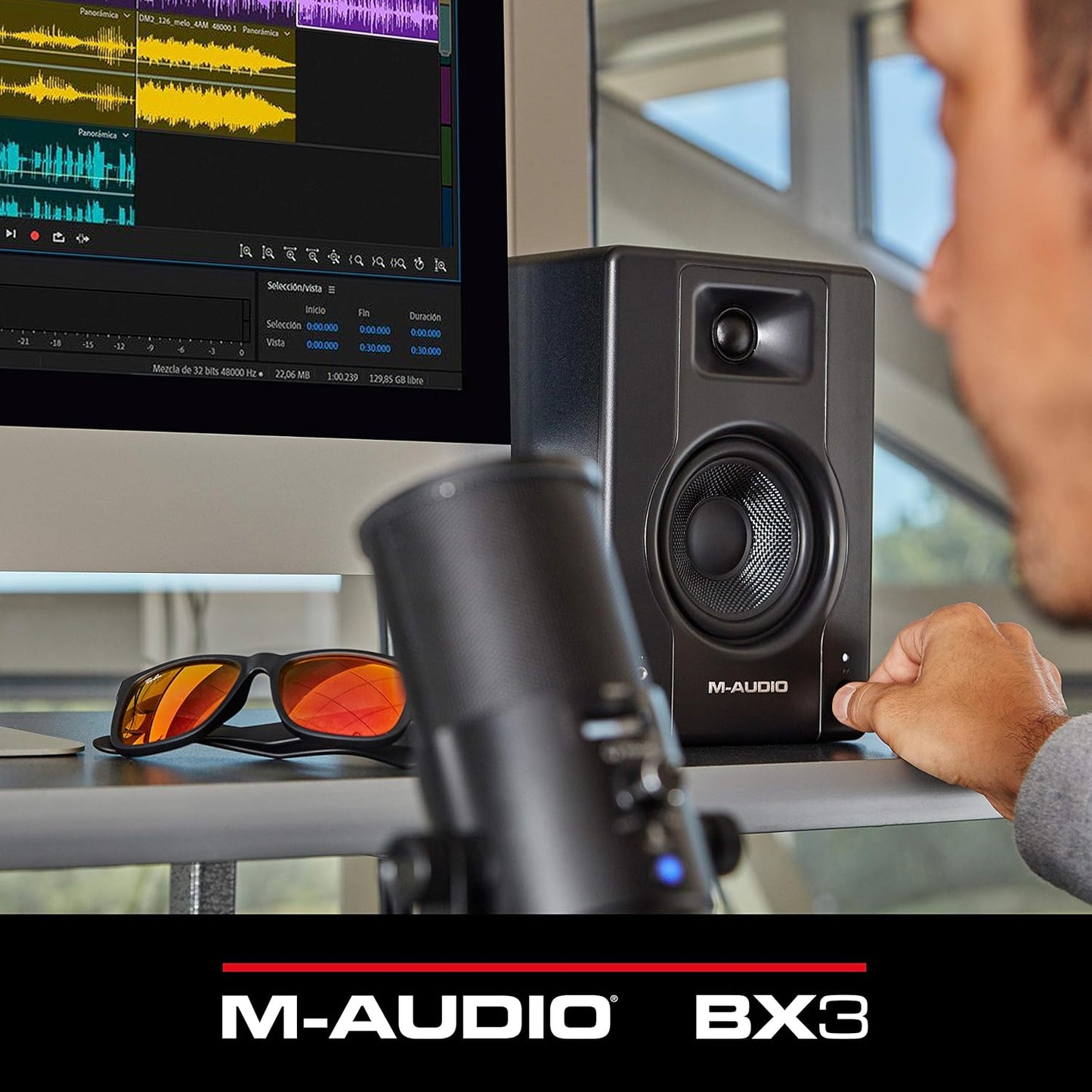 M-Audio BX3 3.5 studio monitor speaker displayed on a desk with audio editing software