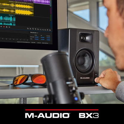 M-Audio BX3 3.5 studio monitor speaker displayed on a desk with audio editing software